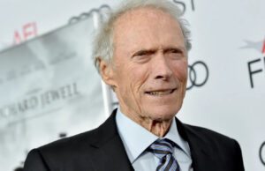 Clint Eastwood at a press event, wearing a navy blazer