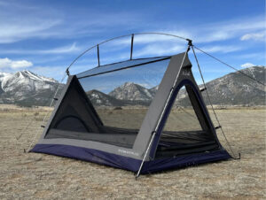 Transparent Sky View tent under starry night sky with camper looking up through mesh ceiling