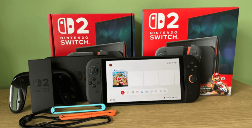 Nintendo Switch 2 console in hand, crowd gathered outside GameStop during launch day, celebrating the return of physical gaming