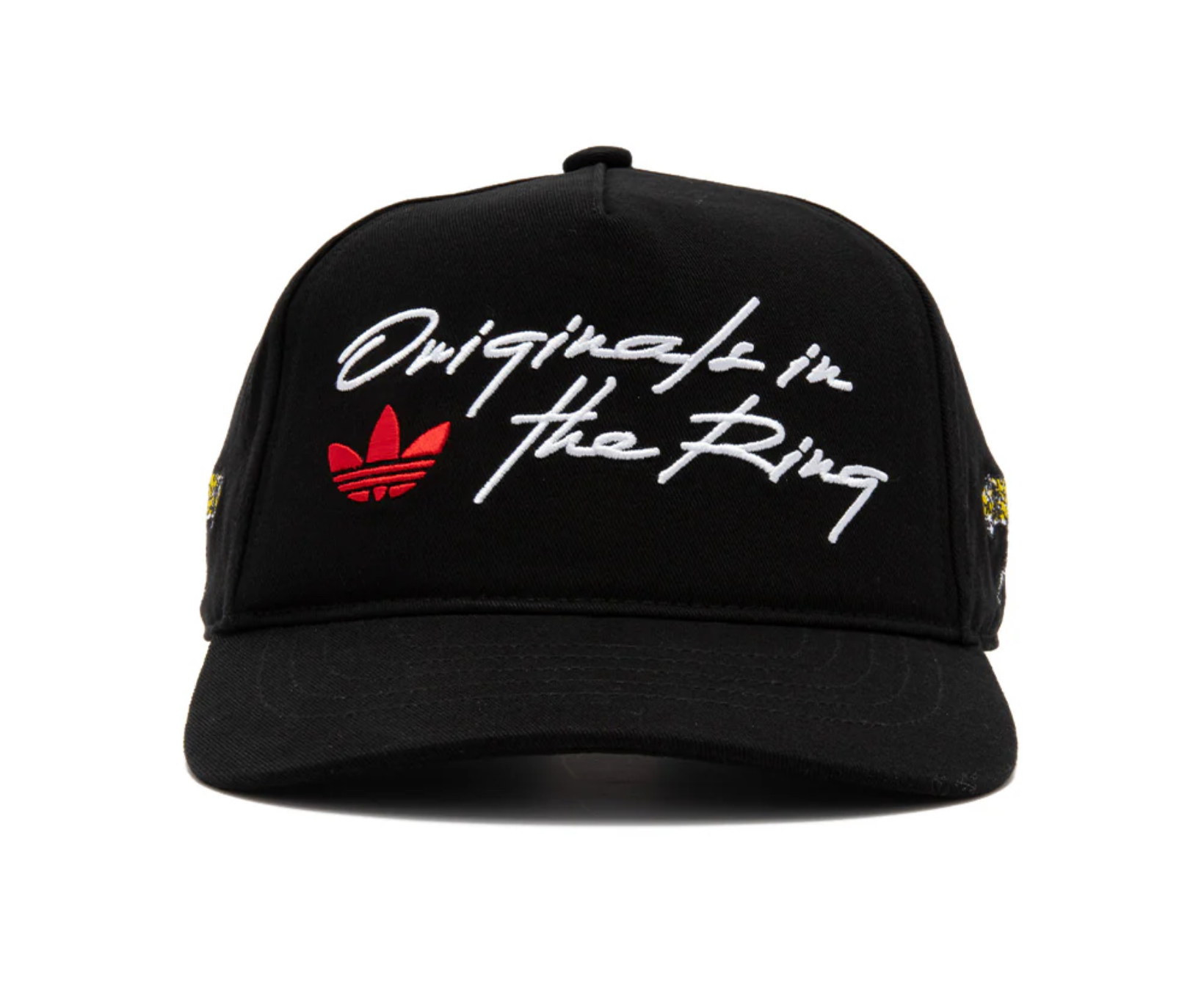 Front view of the adidas “In the Ring” black trucker cap featuring white script embroidery and red Trefoil logo