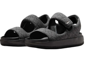 Nike WMNS Calm Sandal SE in black and metallic silver, side view on neutral background
