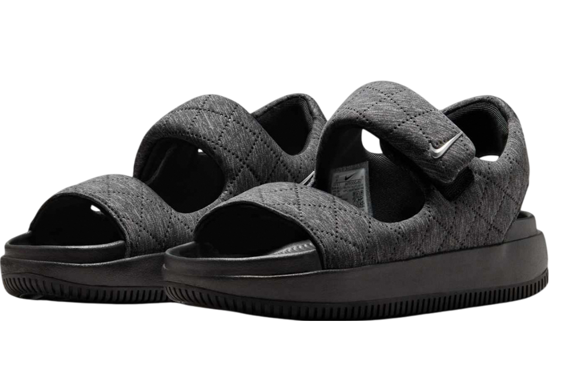 Nike WMNS Calm Sandal SE in black and metallic silver, side view on neutral background