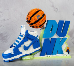LEGO shoe set inspired by Nike Dunk, featuring orange basketball and block letter “DUNK” display with minifigure