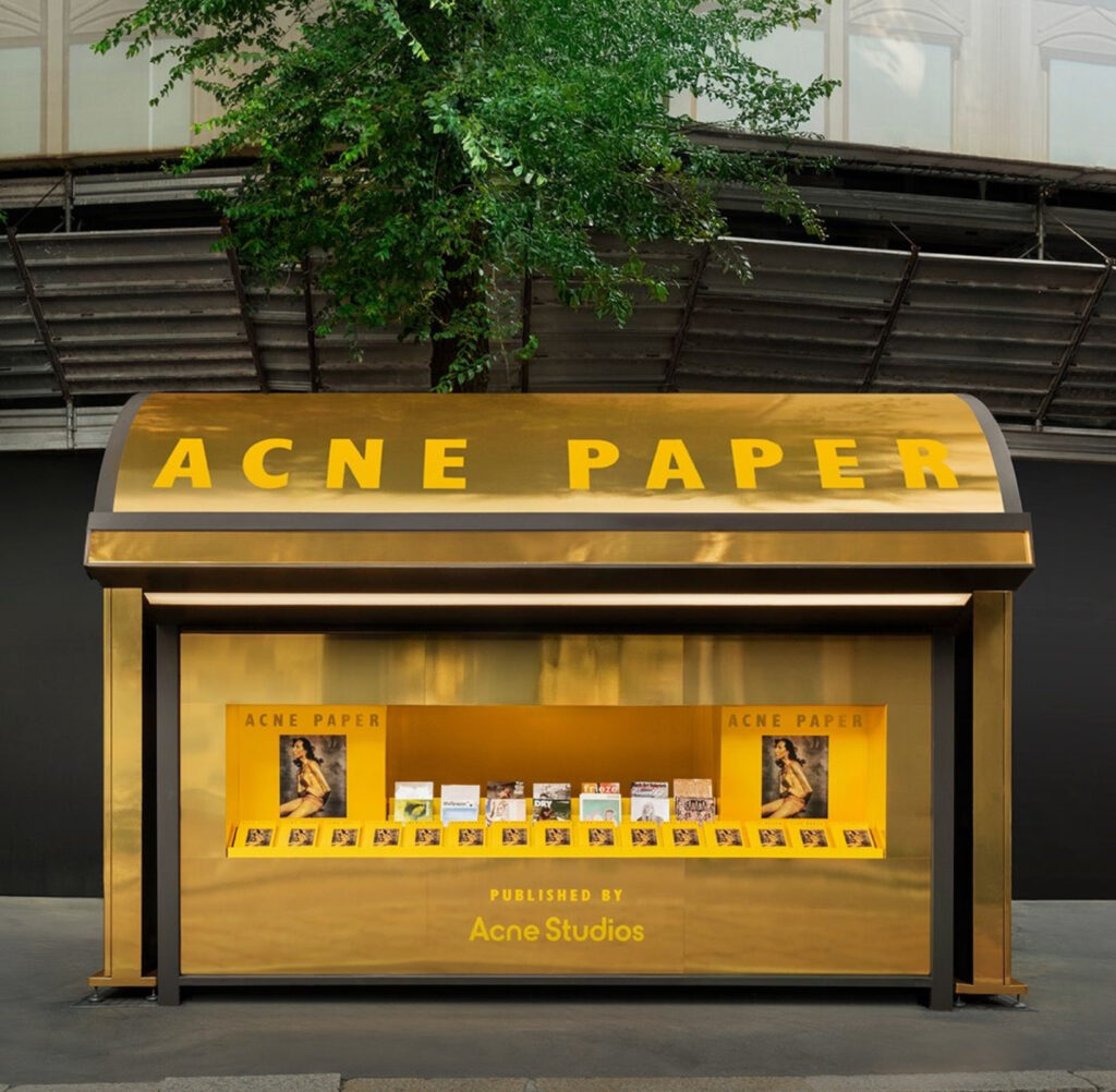 Golden Ticket pop-up kiosk celebrating Acne Paper’s 20th anniversary in Paris with archival magazine giveaways