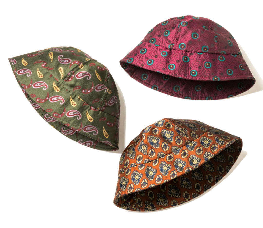 Hender Scheme bucket hat with smooth fabric and retro tie pattern, blending craftsmanship with nostalgic design