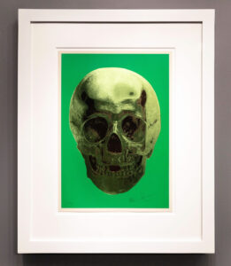 Damien Hirst’s 2012 artwork “Till Death Do Us Part Skull (Green/Brown)” featuring a skull on vivid green background