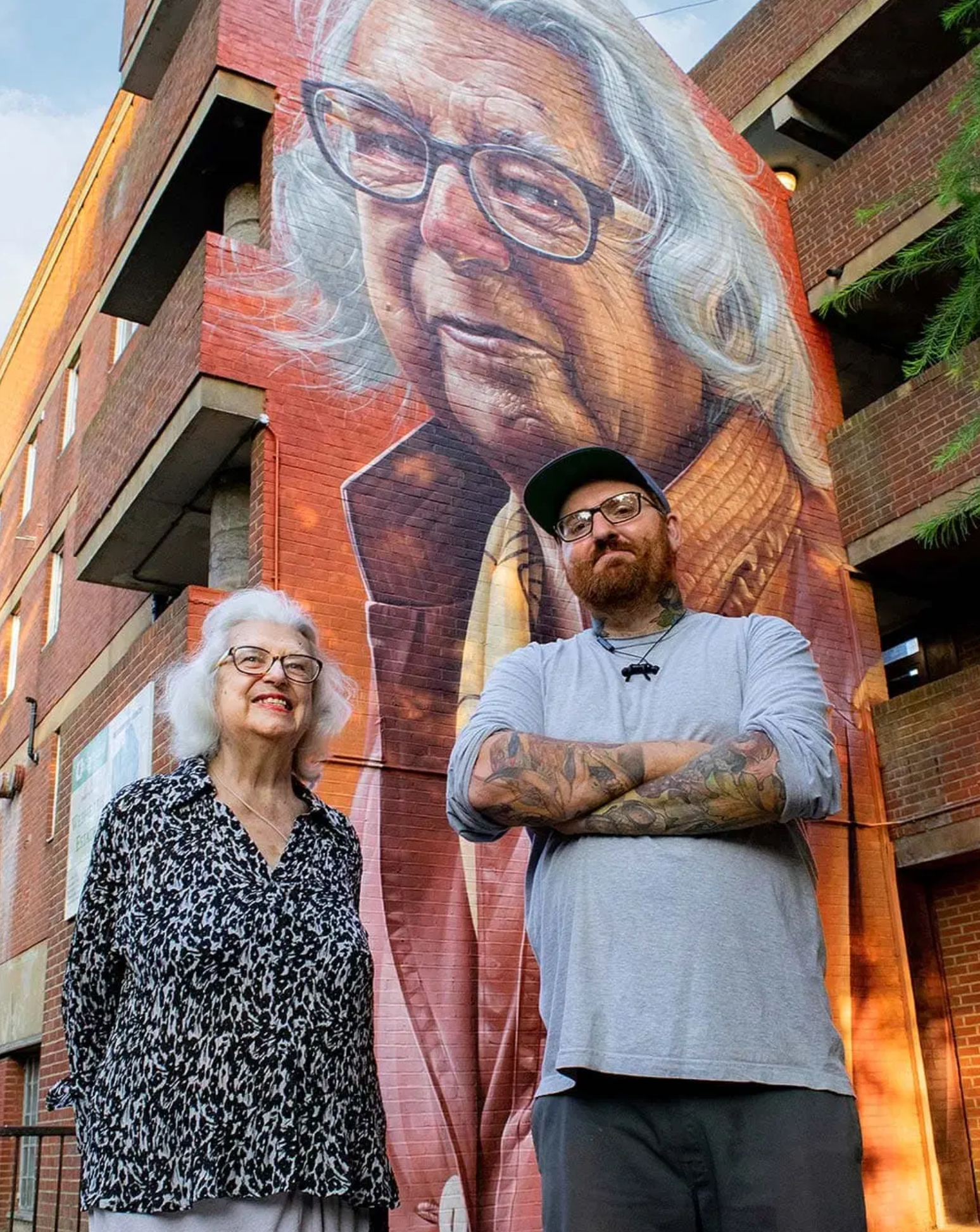 Hyperrealistic mural of a woman painted by Smug One on a building in Webheath Estate, Camden