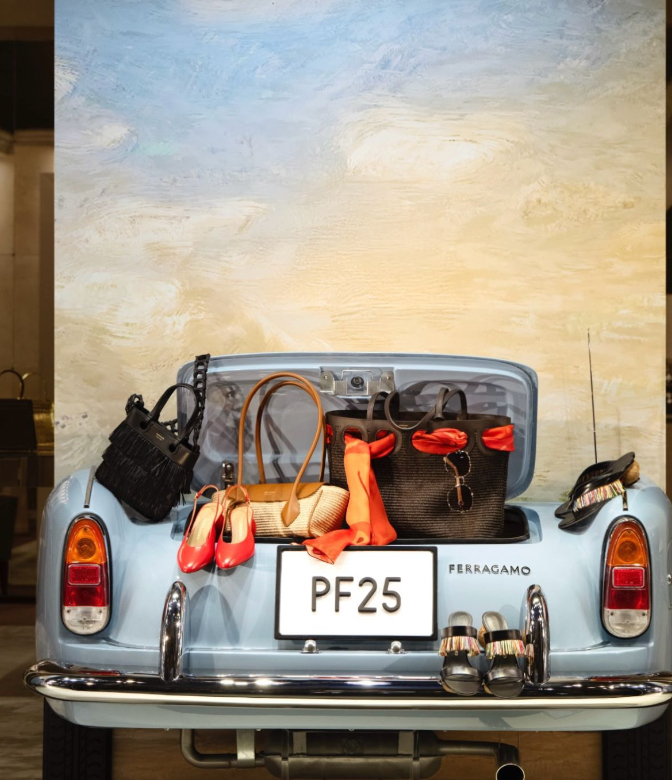 Trunk of a blue Ferragamo car filled with PF25 collection handbags and shoes
