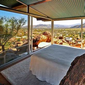 Frey House II perched in the San Jacinto Mountains, desert views, and a natural boulder inside the living space