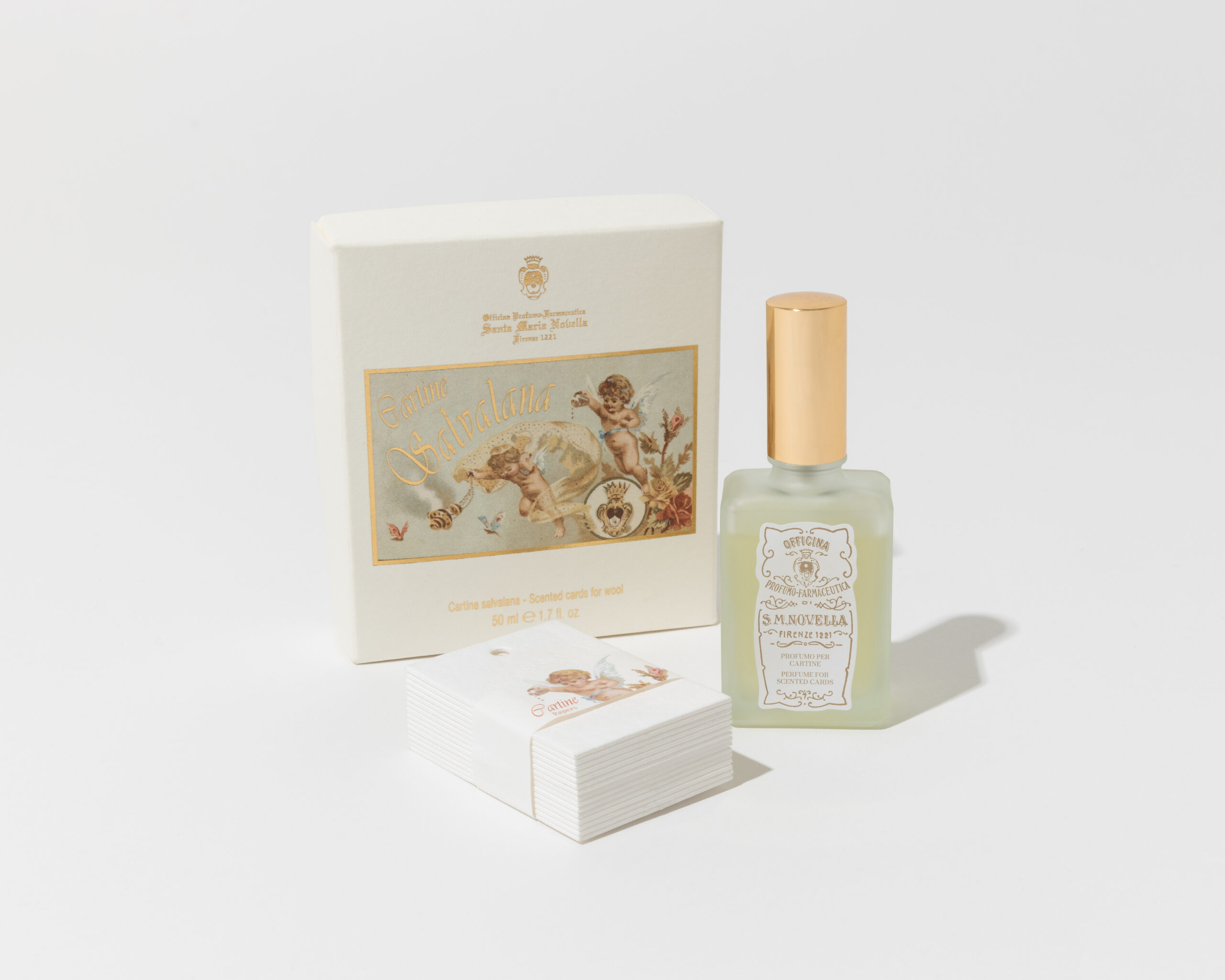 Santa Maria Novella's wool-scenting kit, featuring a box with cherub artwork, a frosted atomizer bottle, and perfumed cards