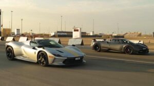 Ferrari Daytona SP3 and Pagani Huayra poised side by side on a drag strip, ready for a high-speed launch