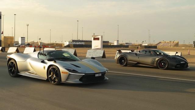 Ferrari Daytona SP3 and Pagani Huayra poised side by side on a drag strip, ready for a high-speed launch