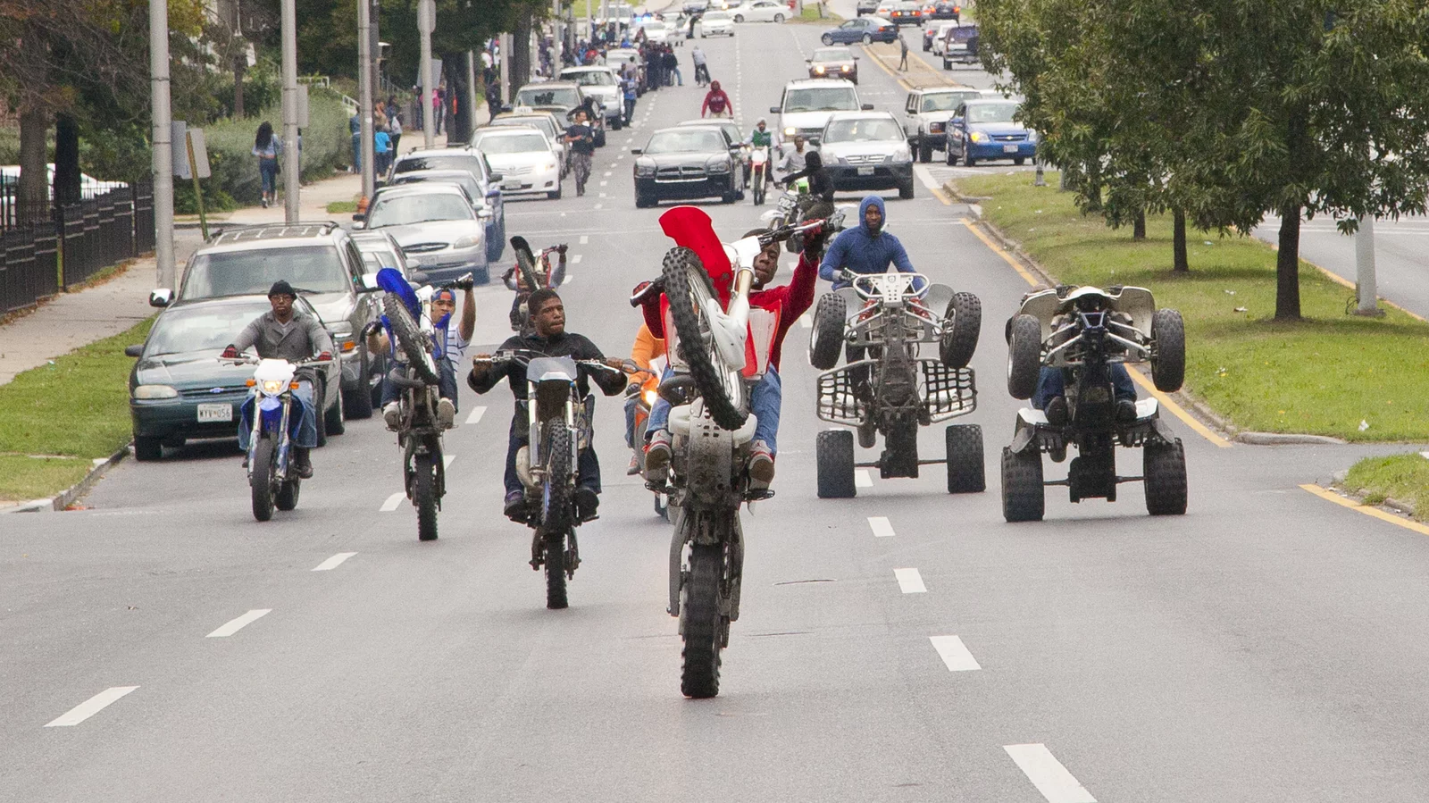 Hundreds of Baltimore bikelife riders perform wheelies through city streets under hovering police helicopters and flashing sirens