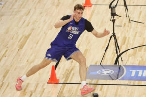 Cooper Flagg at NBA Combine in New Balance training gear, mid-drill with cones and sensors, showcasing elite movement