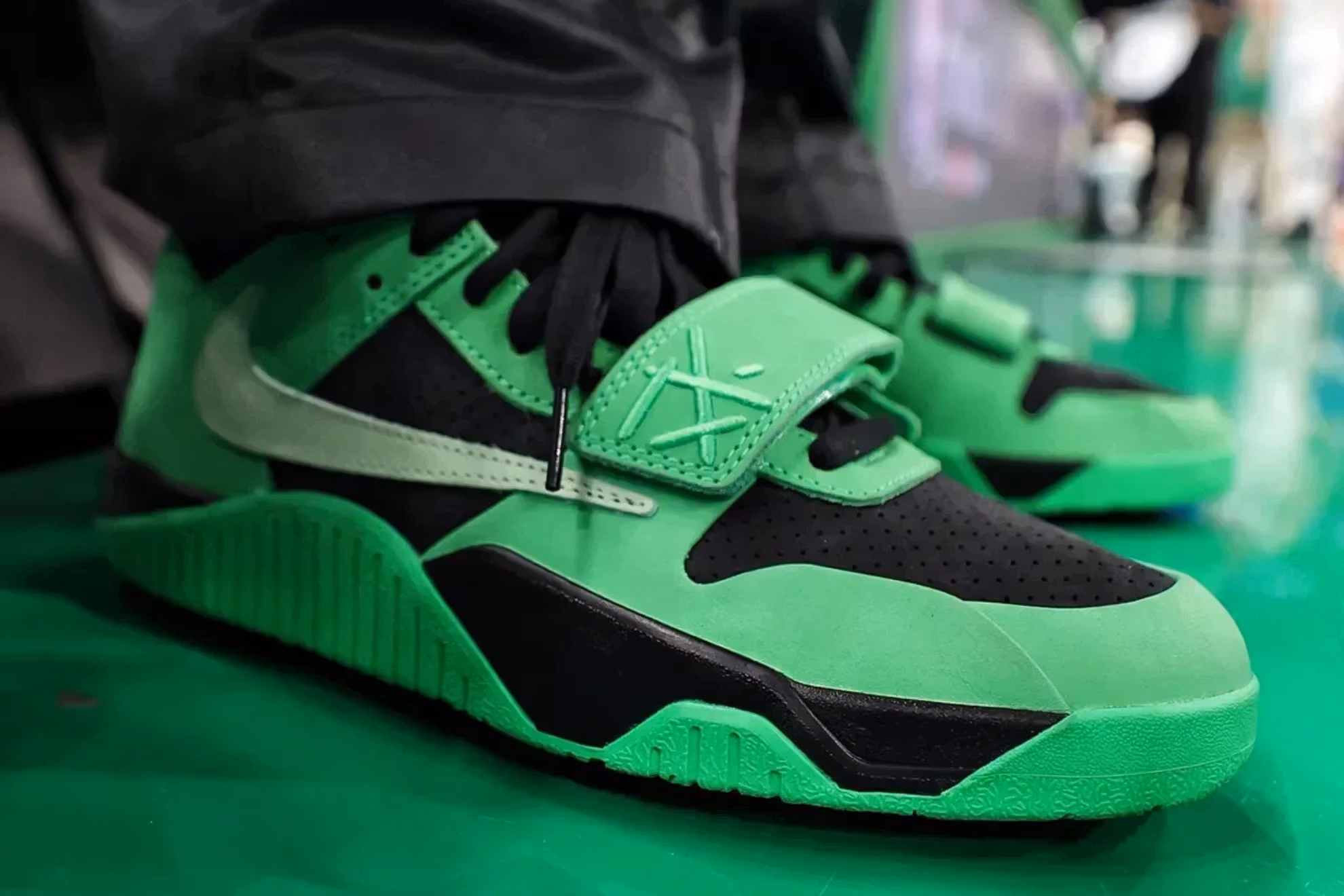Travis Scott’s Jumpman Jack “Green Spark” shoe in bright green with reverse Swoosh and Cactus Jack branding