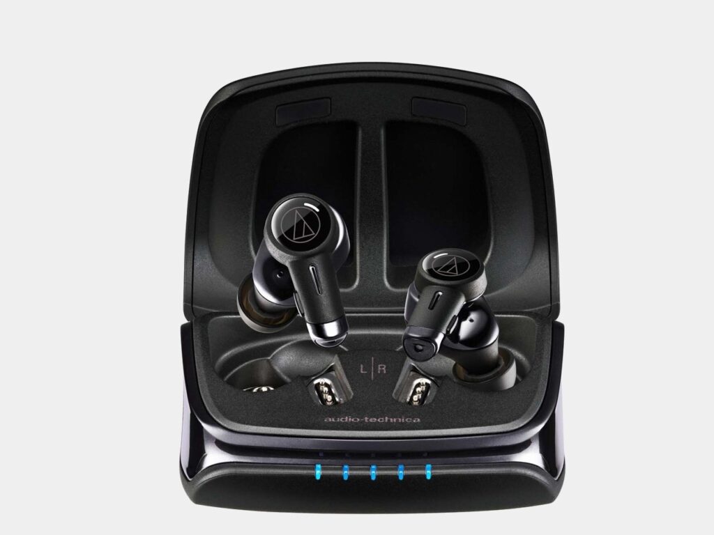 Close-up of Audio Technica ATH-TWX9MK2 earbuds in their charging case, showcasing sleek design and premium finish