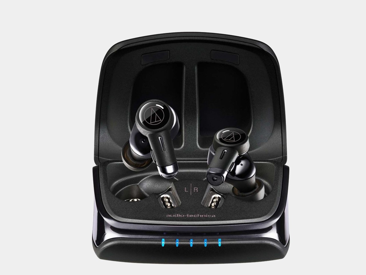 Close-up of Audio Technica ATH-TWX9MK2 earbuds in their charging case, showcasing sleek design and premium finish