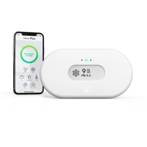 Airthings View Plus indoor air quality monitor with e-ink display showing PM2.5, CO₂, and radon levels, placed in a modern home