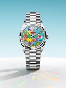 A customized Rolex Day-Date featuring Slawn's clown motif on a peach dial with magenta details and a gold case