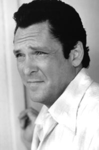 Michael Madsen in a contemplative portrait, embodying his rugged charisma and poetic soul, captured in tribute