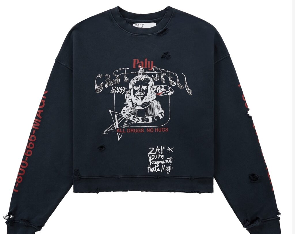 Paly Cast-A-Spell Sweatshirt in black with distressed detailing, featuring occult-inspired graphic print on the front, “ALL DRUGS NO HUGS” text, and red sleeve lettering “1-800-666-MAGK.”