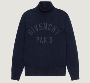 “New Givenchy cotton turtleneck sweater in black featuring bold white GIVENCHY Paris embroidery across the chest, minimalist silhouette with high ribbed collar, photographed against a plain background.”