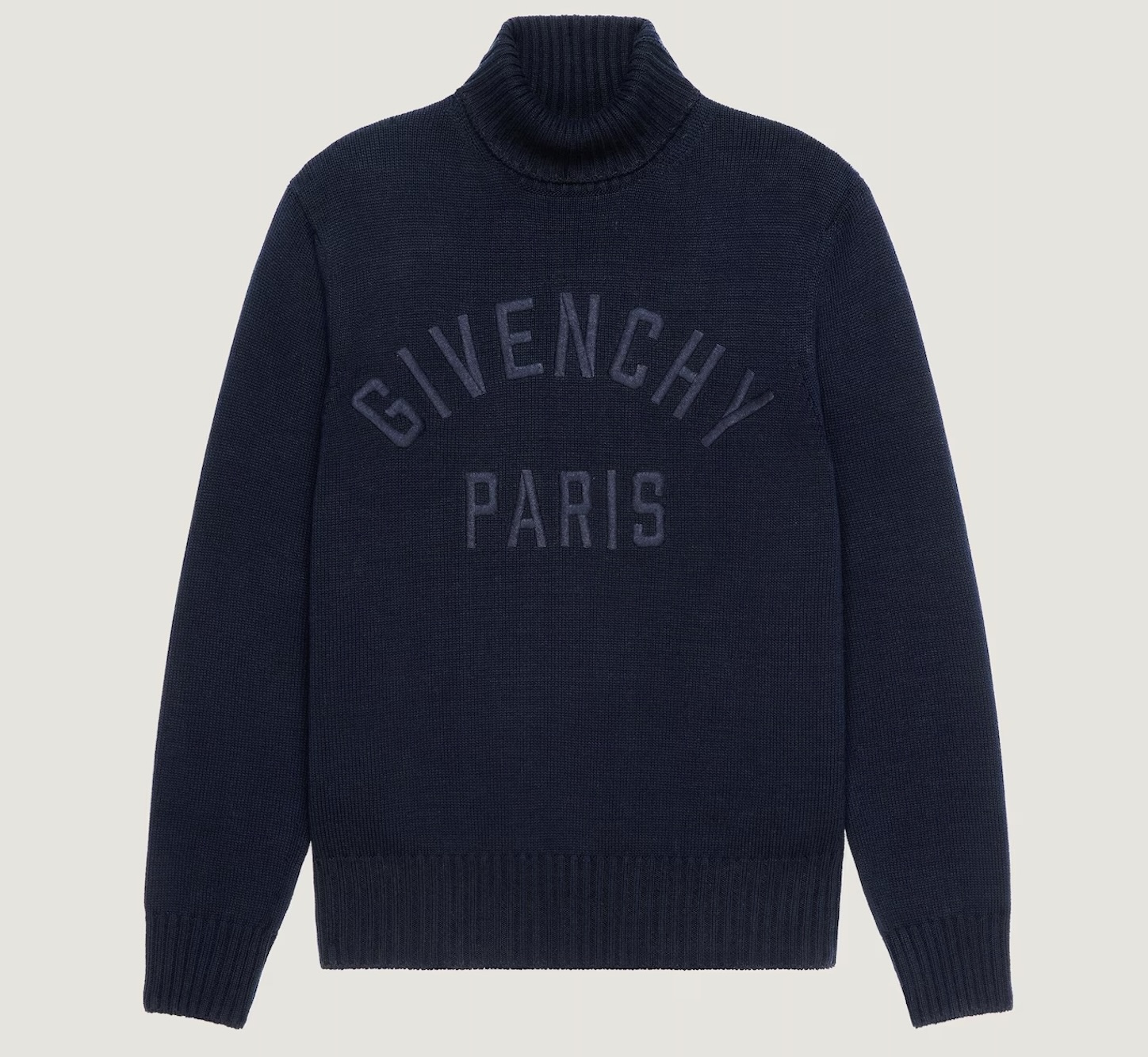 “New Givenchy cotton turtleneck sweater in black featuring bold white GIVENCHY Paris embroidery across the chest, minimalist silhouette with high ribbed collar, photographed against a plain background.”