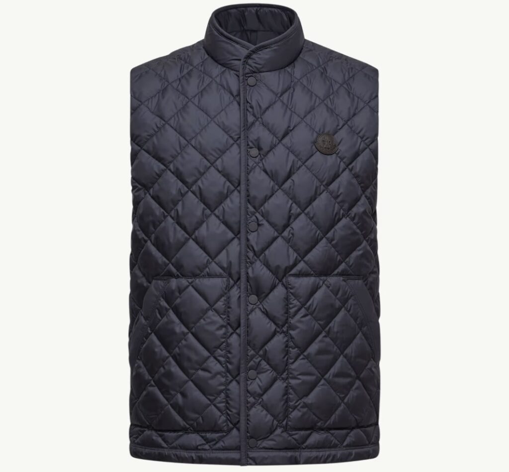 Front view of the Moncler Lycope Diamond-Quilted Down Vest in black, featuring a high collar, snap-button closure, two front pockets, and the Moncler logo patch on the chest.