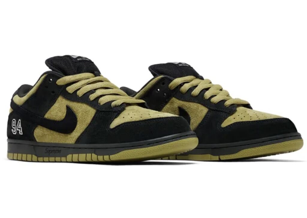 Supreme x Nike SB Dunk Low “Camper Green” sneakers featuring olive green suede uppers, black overlays, black Swoosh, and embroidered “94” detail on the heel, displayed in a three-quarter view.