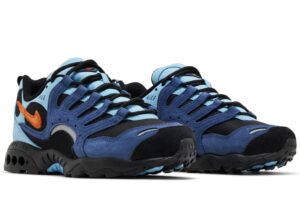 Nike Air Terra Humara “Mystic Navy” shoes featuring layered navy and light blue suede with black mesh accents, a bold orange Swoosh, and rugged black outsole.