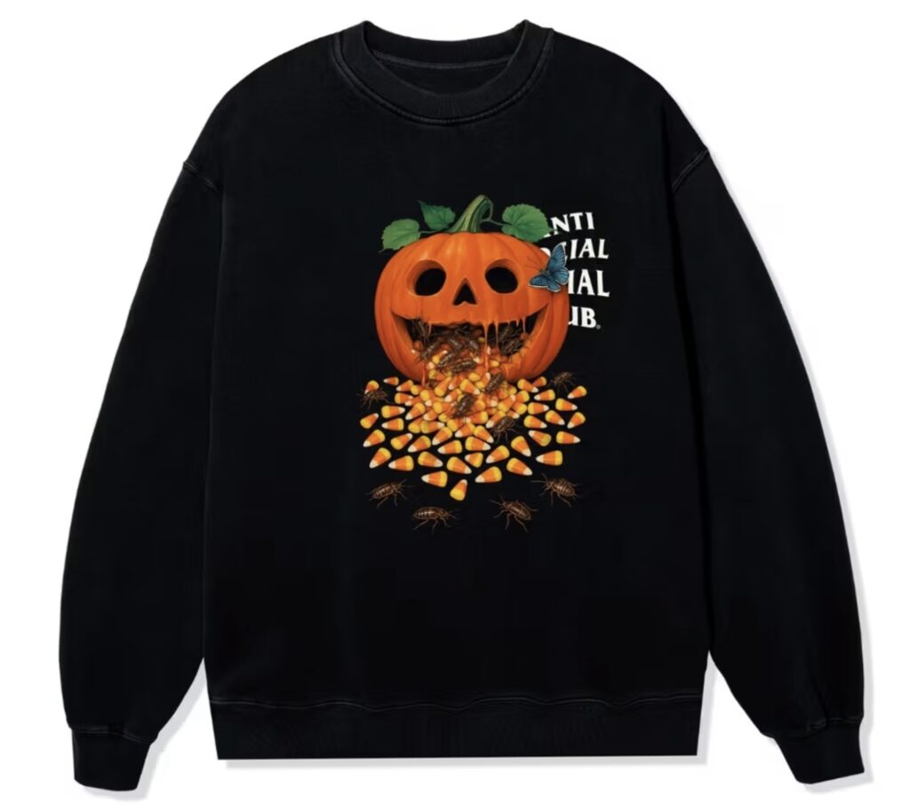 Black Anti Social Social Club sweatshirt featuring a carved jack-o’-lantern vomiting candy corn and crawling cockroaches, with a blue butterfly perched on the pumpkin and the brand’s logo partially visible on the side.