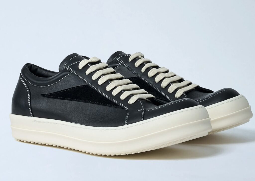A pair of Rick Owens x LN-CC Exclusive Vintage Shoes in black leather with contrasting white stitching, beige laces, and chunky off-white rubber soles, showcasing a minimalist yet avant-garde design.