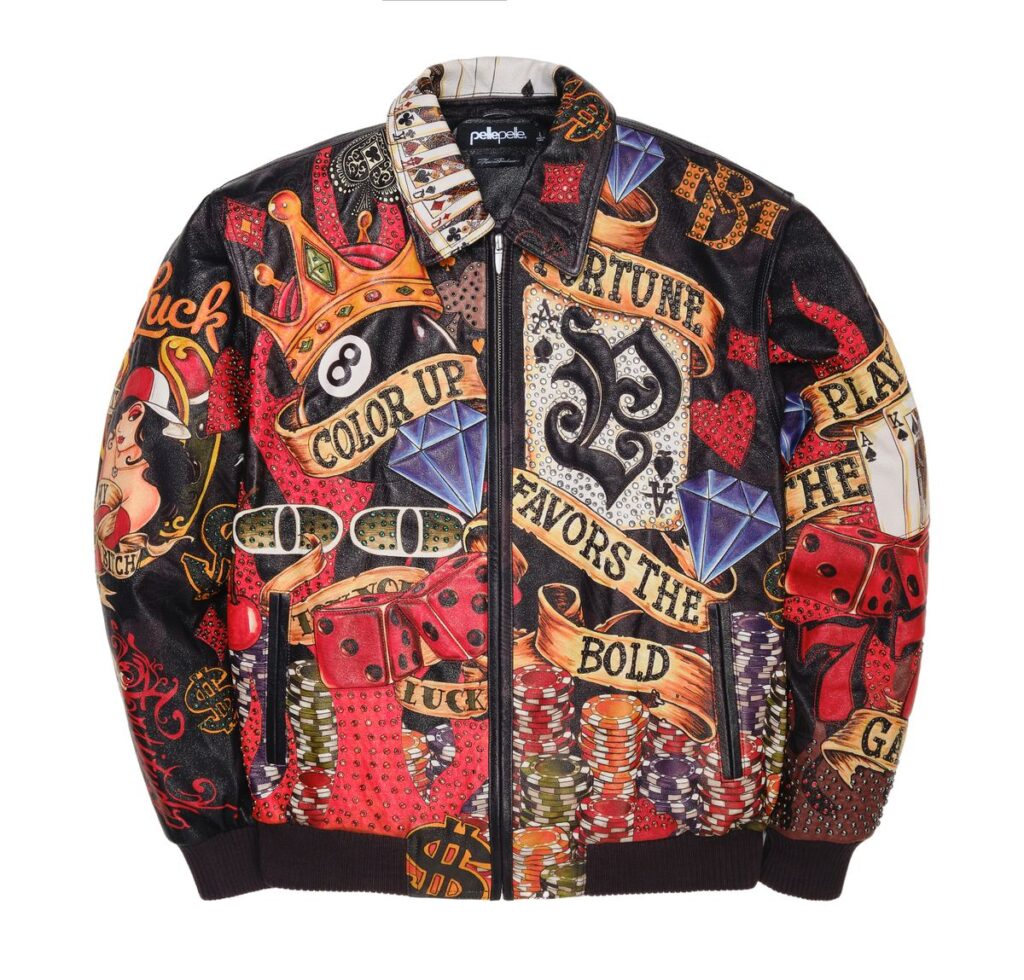 Front view of the Pelle Pelle High Rollers Jacket in black, featuring vibrant casino-themed artwork with dice, poker chips, diamonds, a crown, and playing cards. Embroidered banners read “Fortune Favors the Bold,” “Color Up,” and “Play the Game,” with intricate rhinestone and leather detailing.