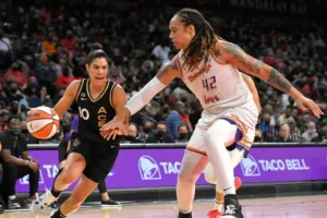 Las Vegas Aces guard drives to the basket while Phoenix Mercury center defends closely during a WNBA championship matchup.