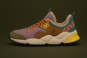 Flower Mountain sneaker featuring a plush lilac shearling upper with tan suede overlays, pink leopard-print accents, and a speckled cream midsole. The shoe includes teal and yellow detailing with a rugged black outsole, blending cozy textures and outdoor-inspired design.