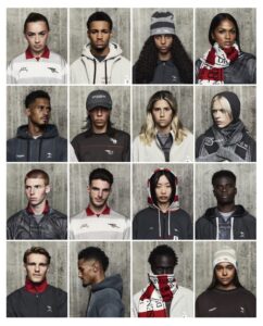 "Grid of Arsenal players and models wearing the A-COLD-WALL x Arsenal capsule collection, including hoodies, jackets, polo shirts, scarves, and beanies, photographed against a concrete wall backdrop, October 2025.