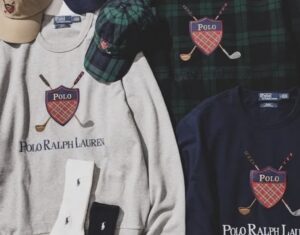Flat-lay image showcasing pieces from the BEAMS × Polo Ralph Lauren Golf Crest Logo Collection, including grey and navy sweatshirts embroidered with the revived 1980s Polo Golf crest, a Black Watch tartan shirt with matching cap, a beige cap, and white and black socks featuring the Polo logo. The composition highlights the capsule’s blend of vintage heritage and modern craftsmanship.