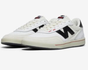 New Balance NM440NO2 White skate shoe, angled front view showing black ‘N’ logo, leather and mesh upper, and retro-inspired design.