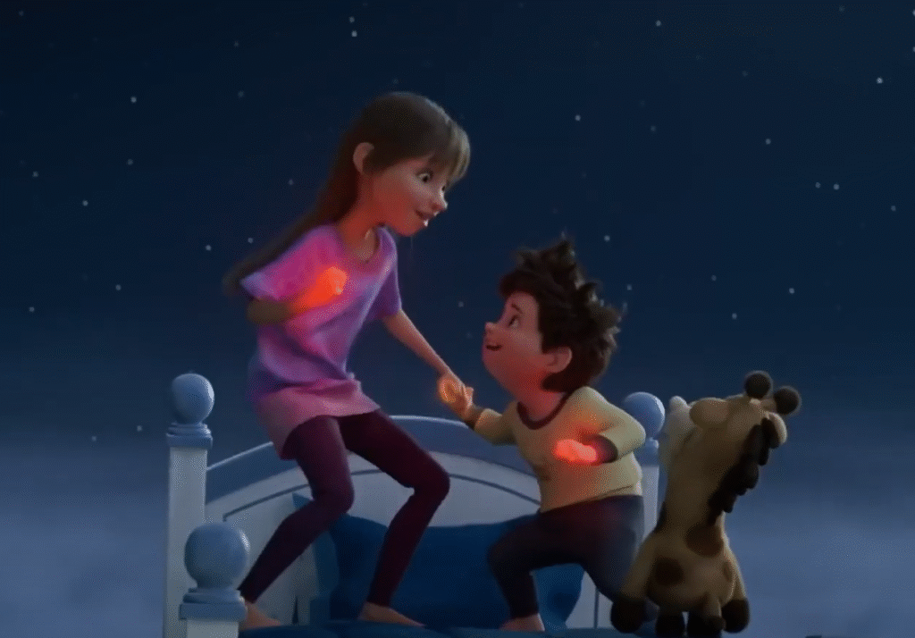 Stevie and Elliot from Netflix’s In Your Dreams standing on a bed under a starry night sky, holding glowing dream orbs, with their toy giraffe Baloney Tony beside them.