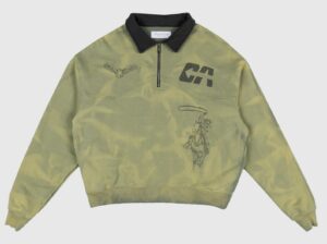 Dead Atlantic “Money Quarter Zip” sweatshirt in aged green with black contrast collar. Features ozone-treated enzyme wash, pre-faded cowboy and hawk graphics, and bold “CA” print on chest. Made in California from heavyweight French terry cotton.