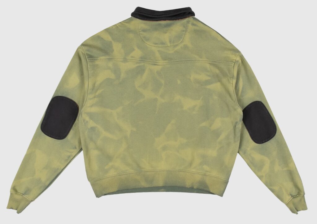 Back view of Dead Atlantic “Money Quarter Zip” sweatshirt in aged green enzyme-washed cotton. Features contrasting black elbow patches and collar, with a subtly marbled ozone-treated finish. Constructed from heavyweight French terry for a naturally aged California-made look.