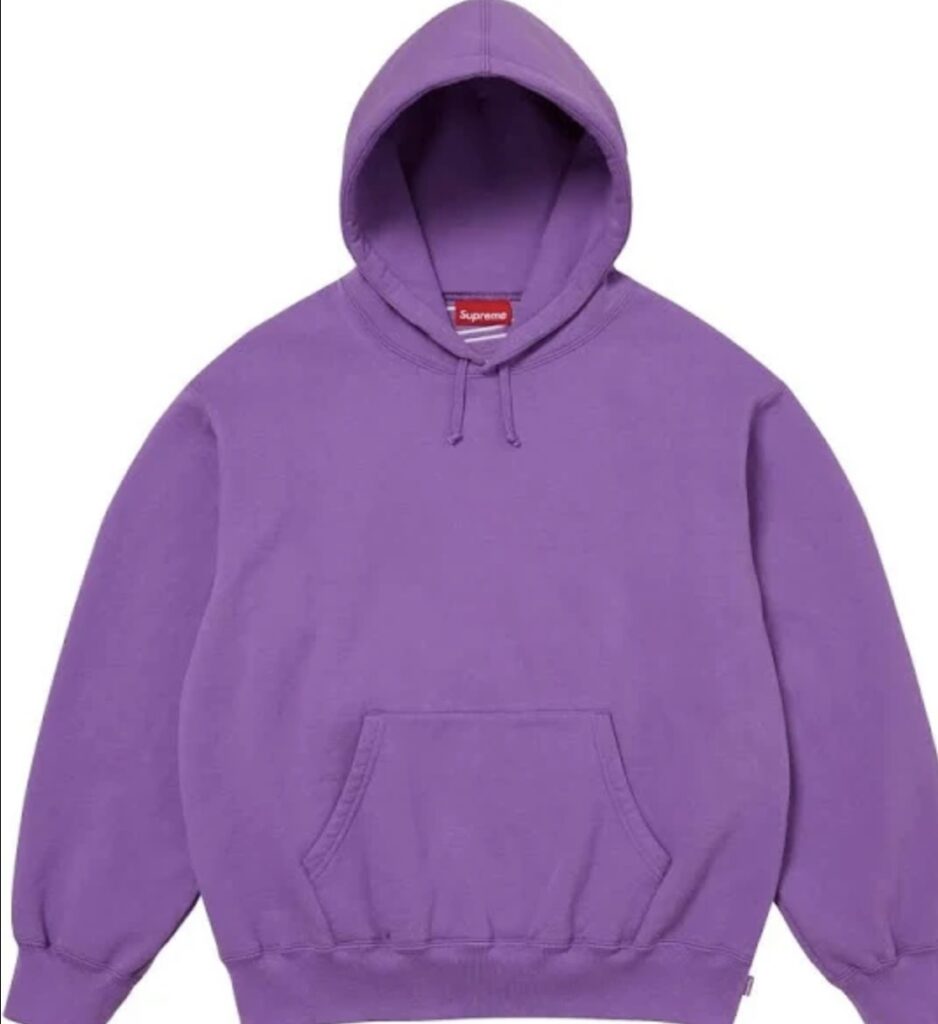 Front view of the Supreme Satin Appliqué Hoodie in purple, featuring a minimalist design with a kangaroo pocket, drawstring hood, and red Supreme neck tag, crafted from heavyweight cotton fleece for the FW25 collection.