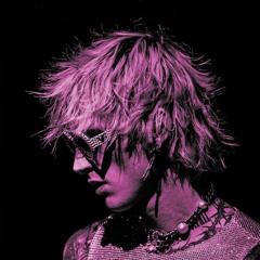 Gun Kelly in a high-contrast magenta portrait, facing downward with tousled platinum hair, wearing angular rhinestone sunglasses and layered punk jewelry against a black background