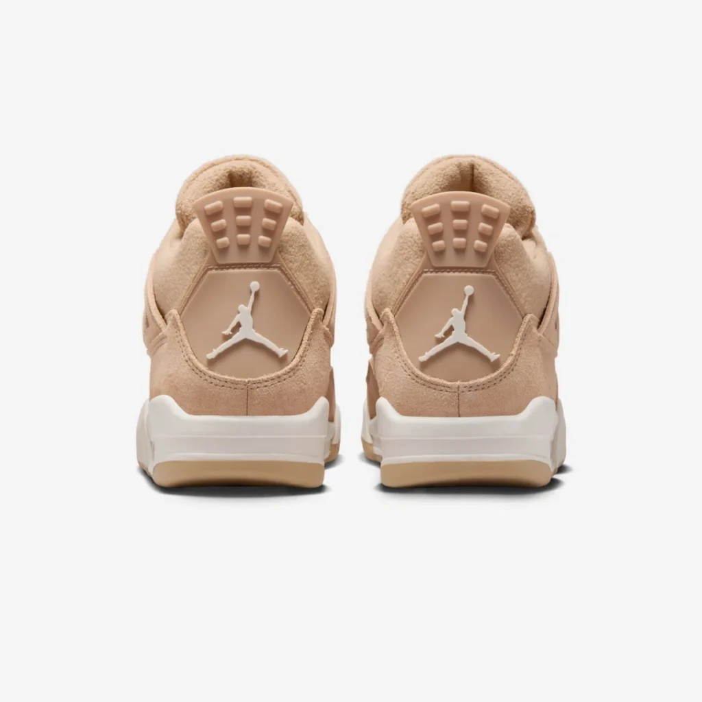 Rear view of the Air Jordan 4 WMNS “Cozy Girl” sneakers showing the soft beige hairy suede uppers, cream midsoles, and tonal heel tabs with white Jumpman logos, photographed against a clean white background