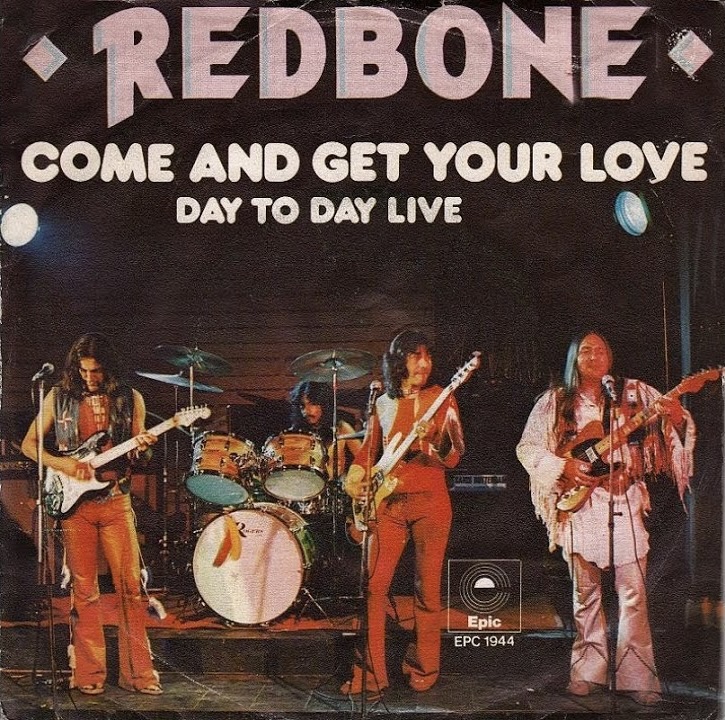 Cover artwork for Redbone’s 1974 single “Come and Get Your Love / Day to Day Live,” showing the band performing on stage with guitars, drums, and vocals, dressed in 70s outfits, released by Epic Records.