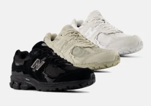 Three pairs of New Balance 2002R sneakers from the Protection Pack in black, beige, and off-white colorways, displayed side by side on a light background.