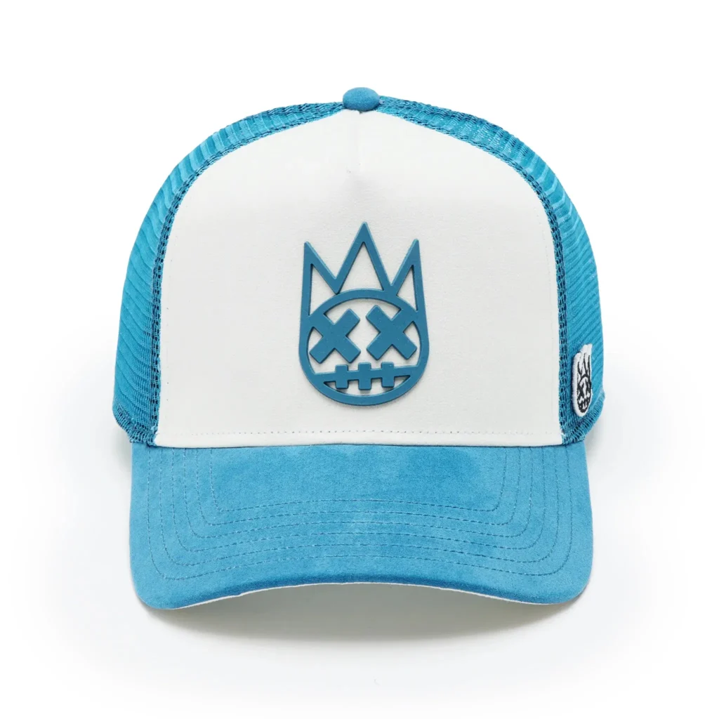 Front view highlighting the raised blue rubber Shimuchan emblem on the white suede crown.