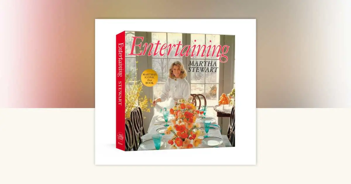 Photograph of the 2025 facsimile edition of Martha Stewart’s “Entertaining,” featuring its original 1982 cream dust jacket with gold serif title and vintage table setting imagery