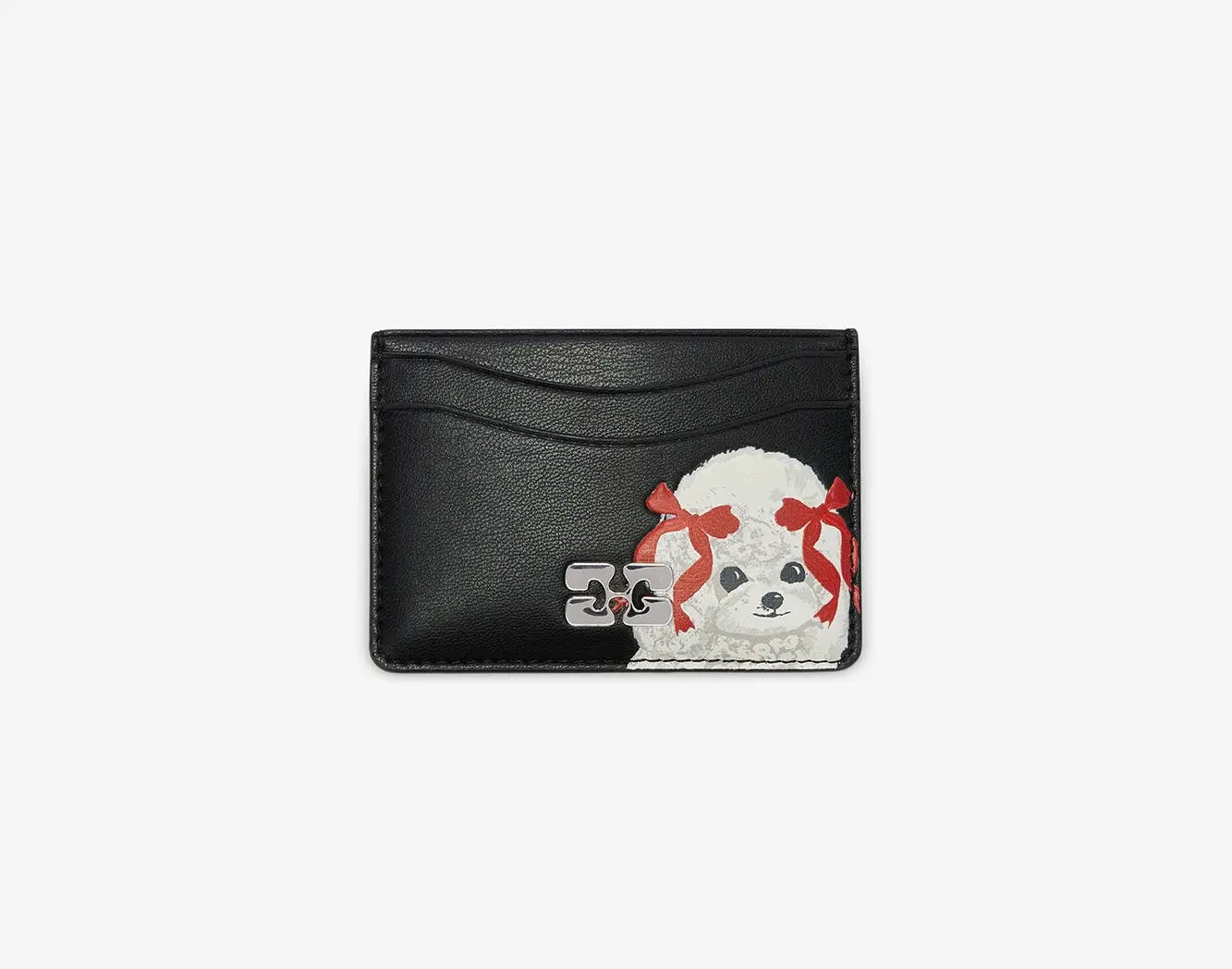 Close-up of the Ganni Bou Card Holder in black recycled leather featuring an illustration of a white poodle with red ribbons and a silver Ganni logo plaque, photographed against a plain white background