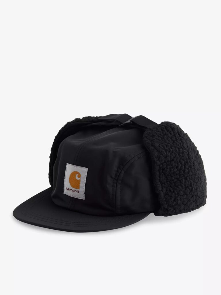 Carhartt WIP Oltera Ear-Flap Woven Cap in black with fleece-lined ear flaps, featuring the signature brown Carhartt square logo patch on the front panel